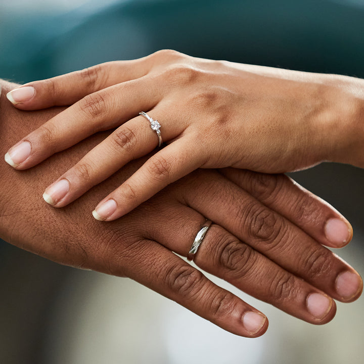 A couple's hands adorned with the Coralie Beauty Couple Rings from Palmonas